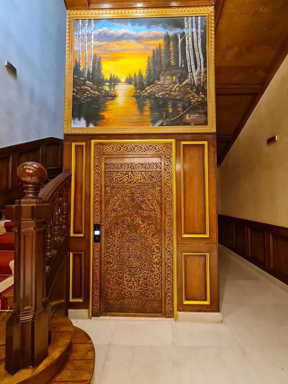 A decorative interior door framed by gold tones, artwork and warm light